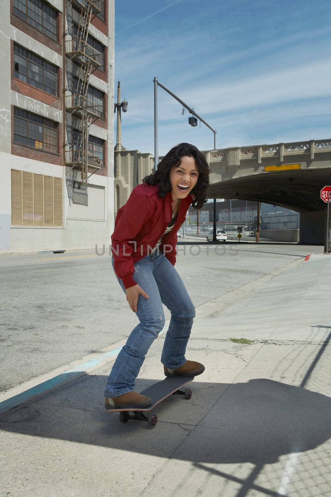 Young woman skateboarding at a roadside