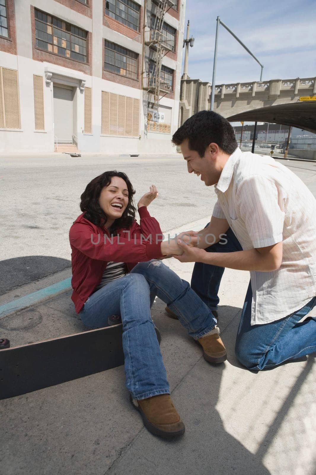 Young man helping a young woman to stand up