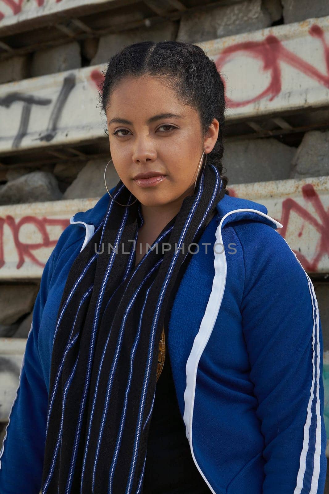 Portrait of a young woman standing in front of a wall