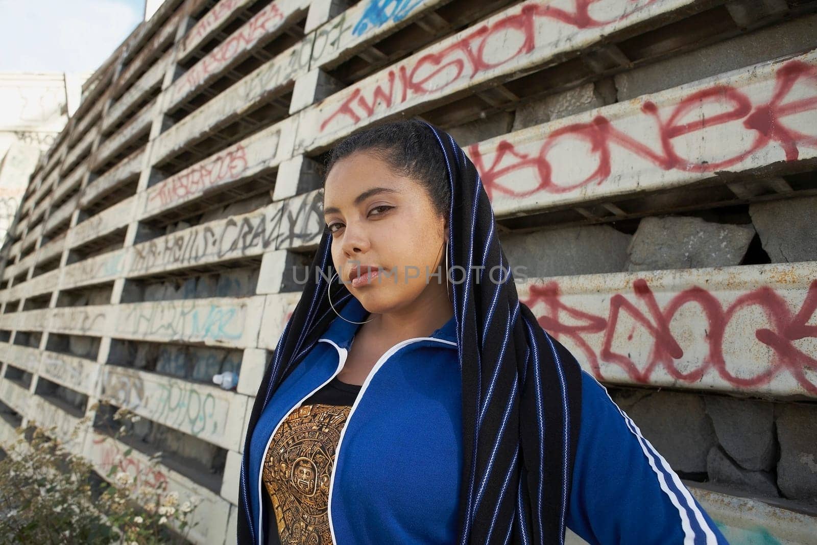 Portrait of a young woman covering her head with a scarf