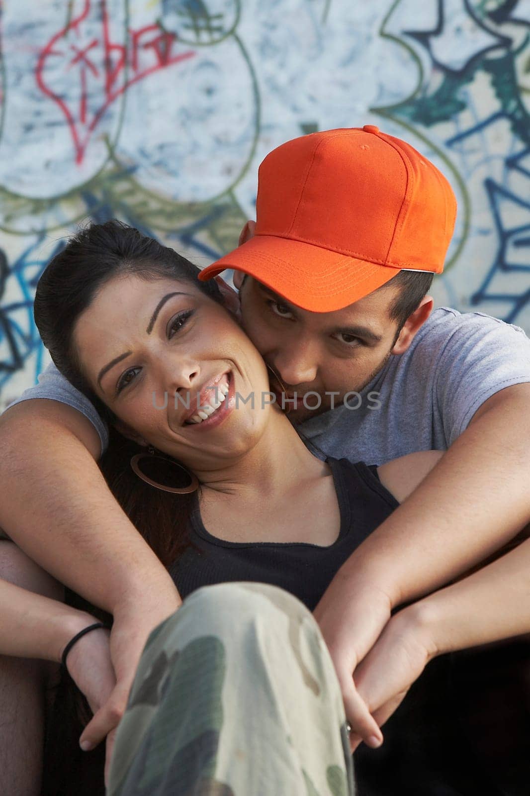 Portrait of a young man embracing a young woman from behind