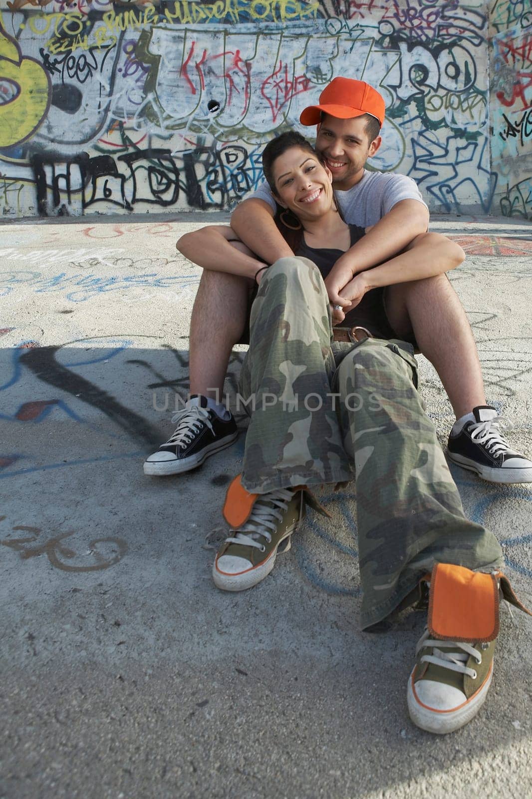 Portrait of a young man embracing a young woman from behind