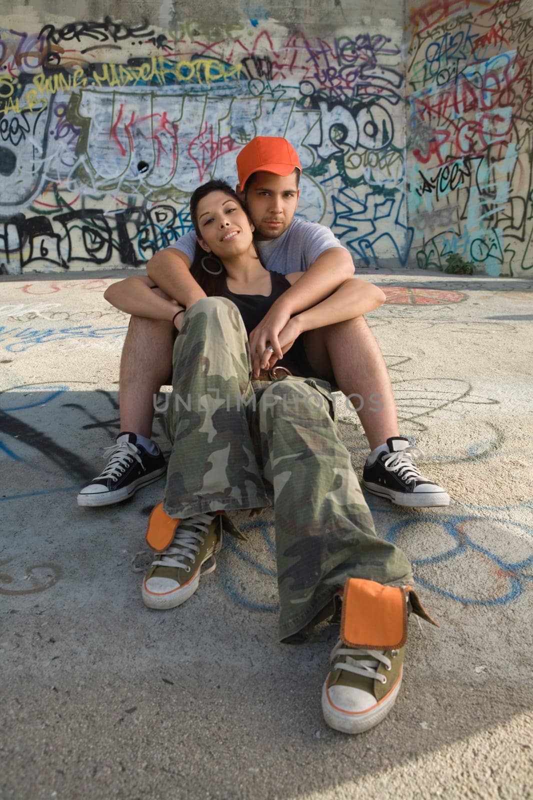 Portrait of a young man embracing a young woman from behind