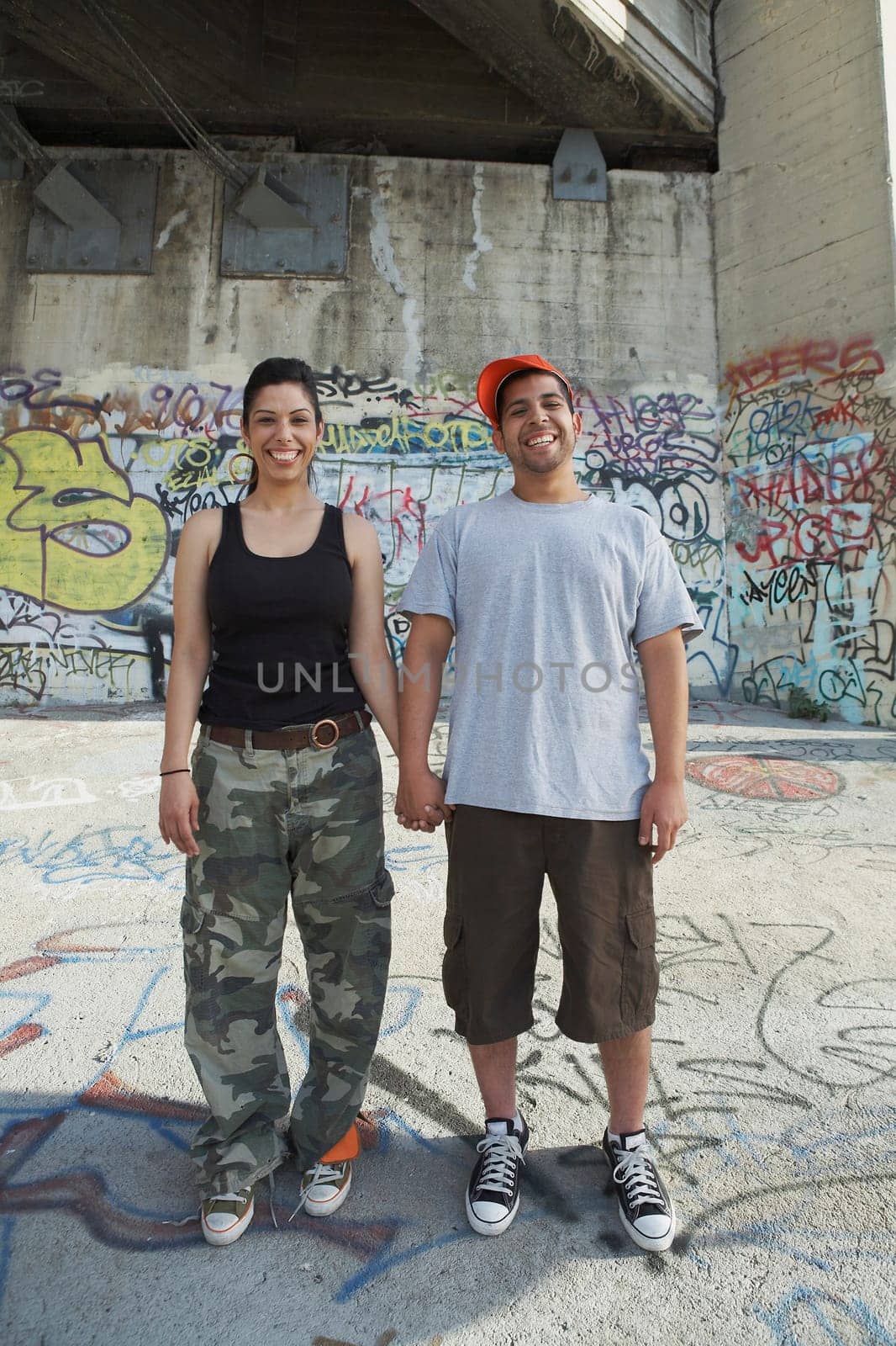 Portrait of a young couple holding each other's hand and smiling