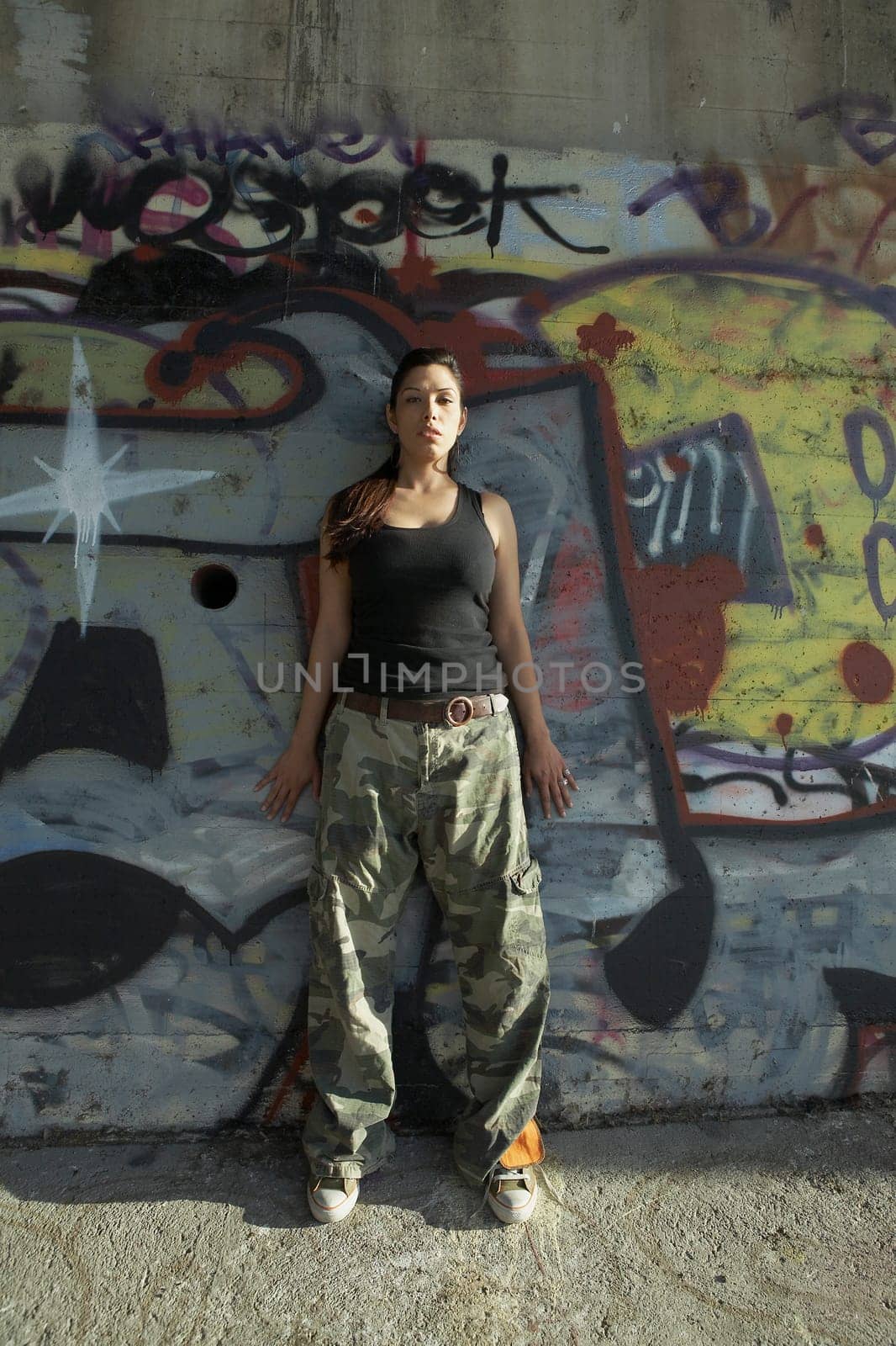 Young woman leaning against a wall