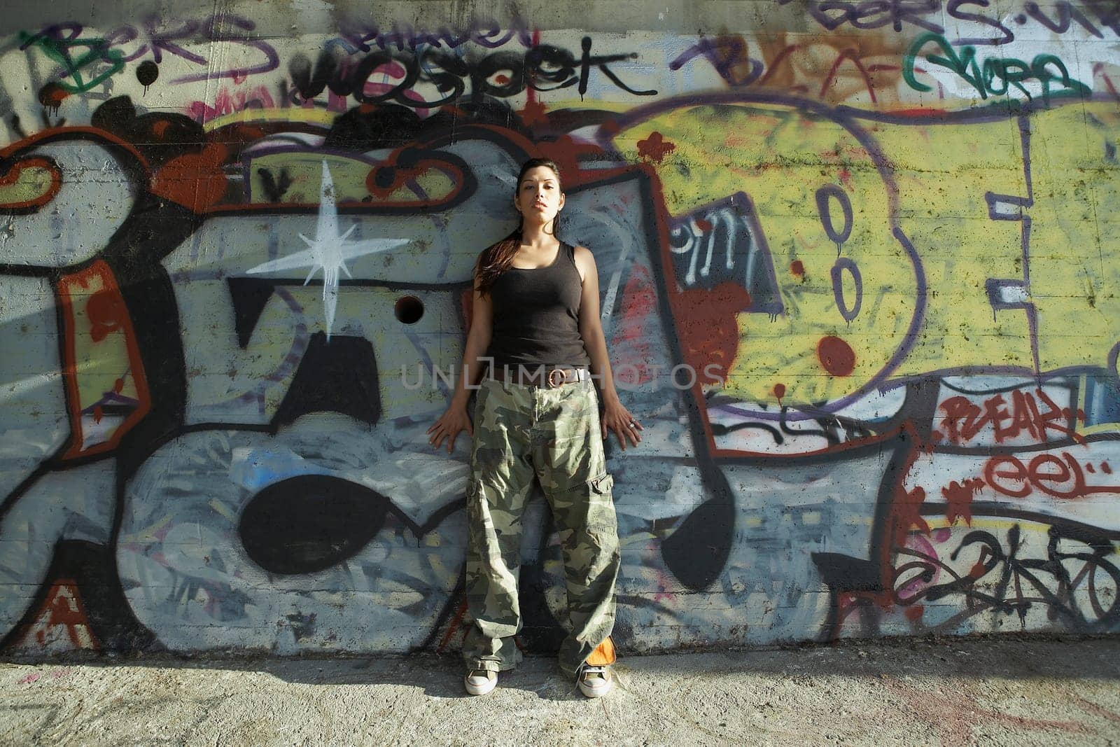 Young woman leaning against a wall