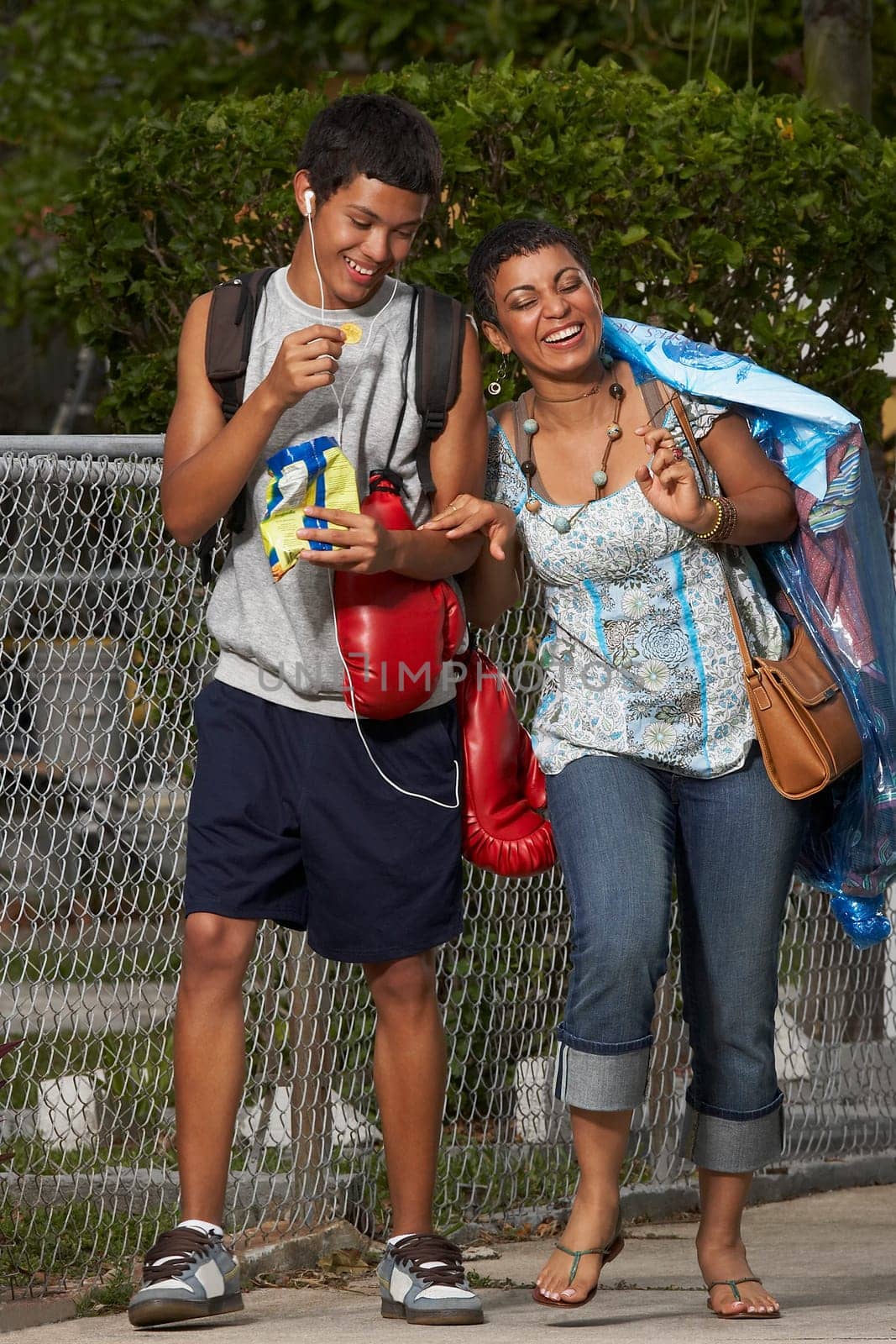Teenage boy and his sister walking on the walkway