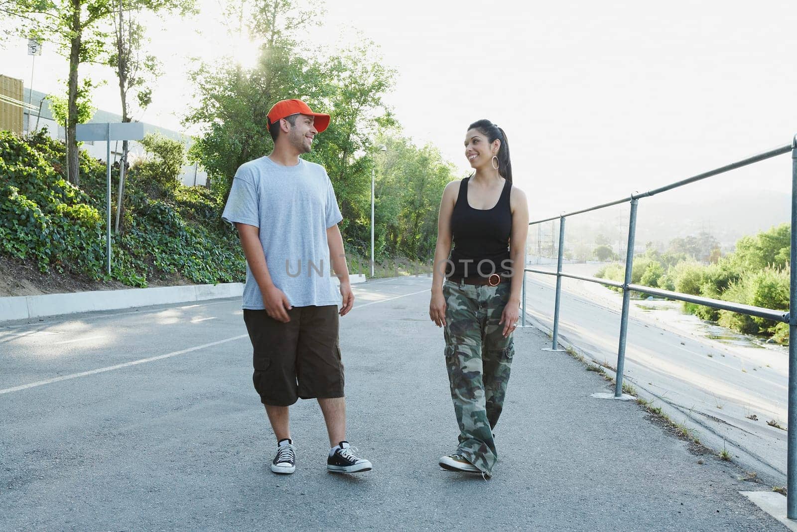 Young couple looking at each other and smiling on the road
