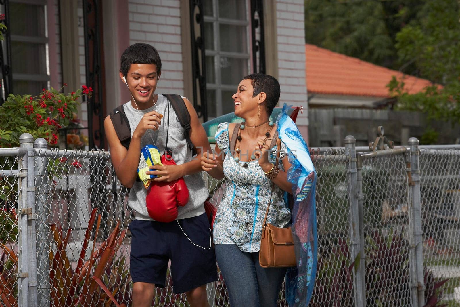 Teenage boy and his sister walking and smiling