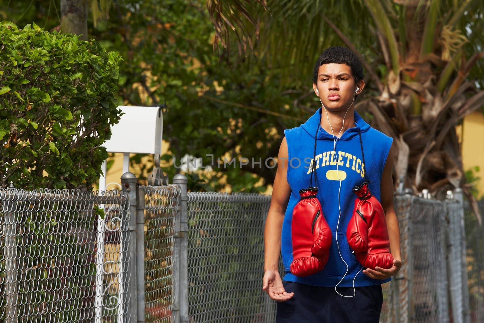 Teenage boy listening an ipod and walking