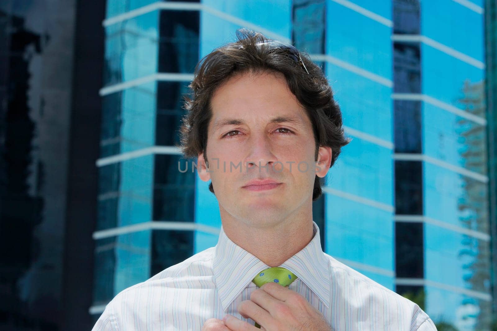 Portrait of a businessman adjusting his tie