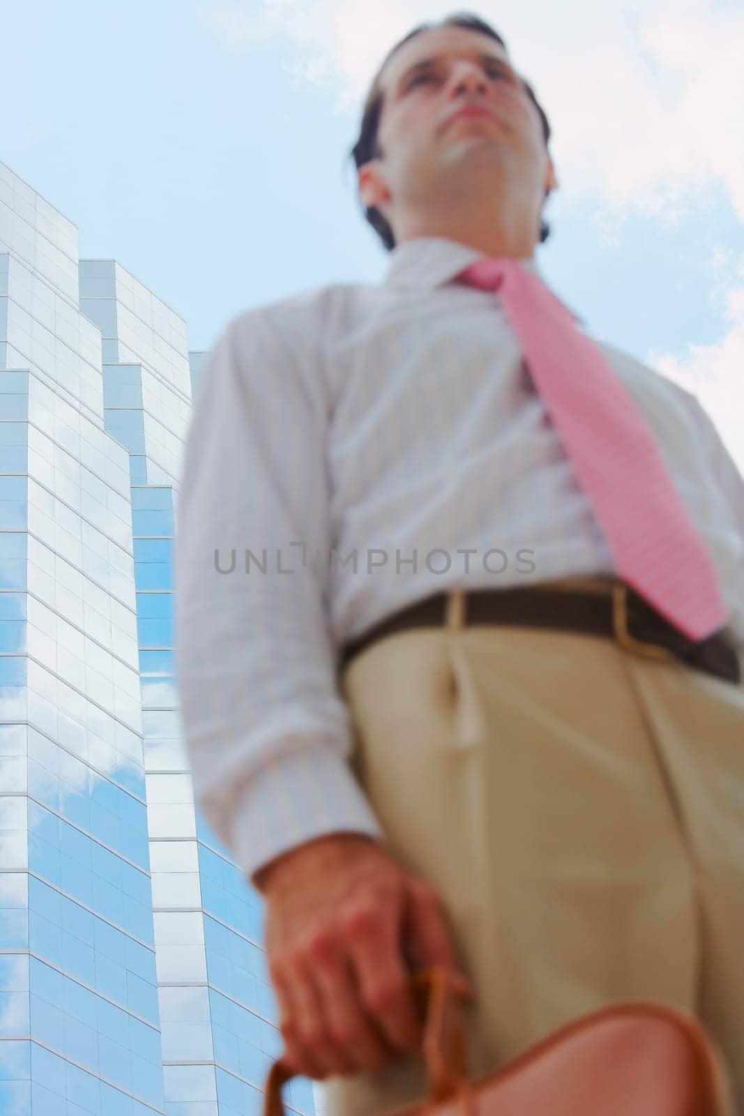 Low angle view of a businessman holding a handbag