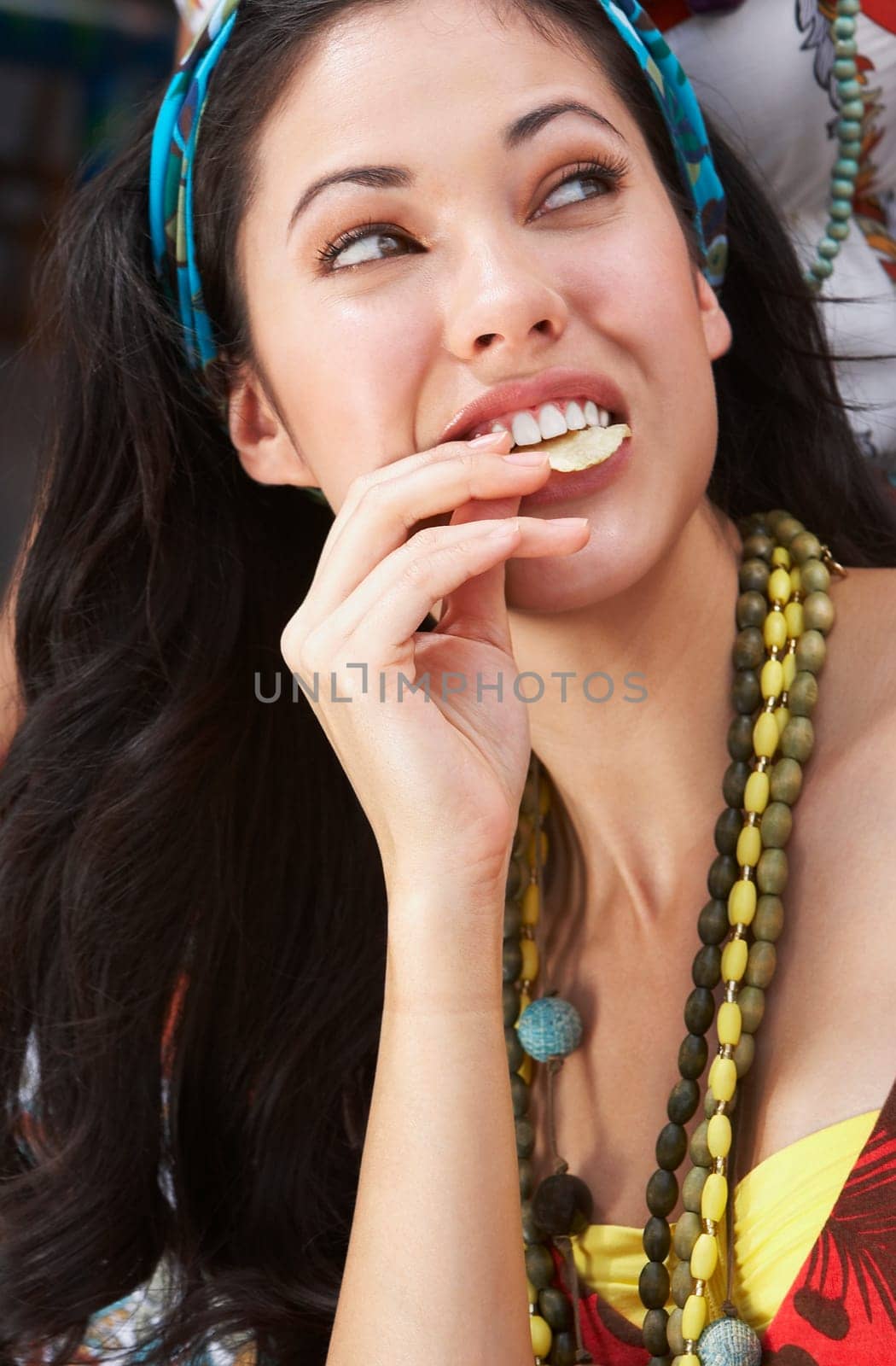 Close-up of a young woman eating potato chips