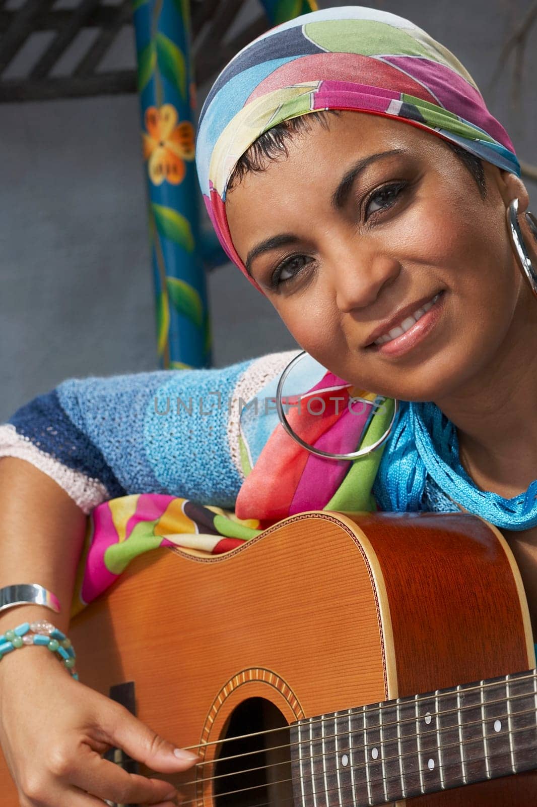 Portrait of a young woman playing a guitar