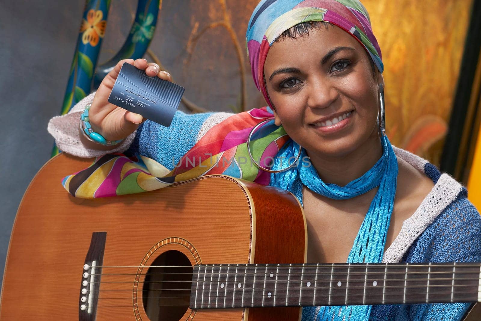 Portrait of a young woman showing a credit card