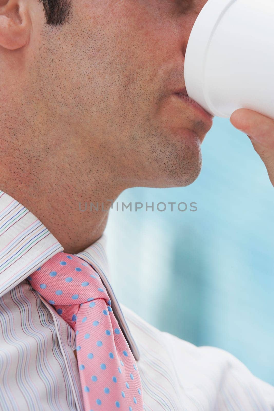 Close-up of a businessman drinking cold drink