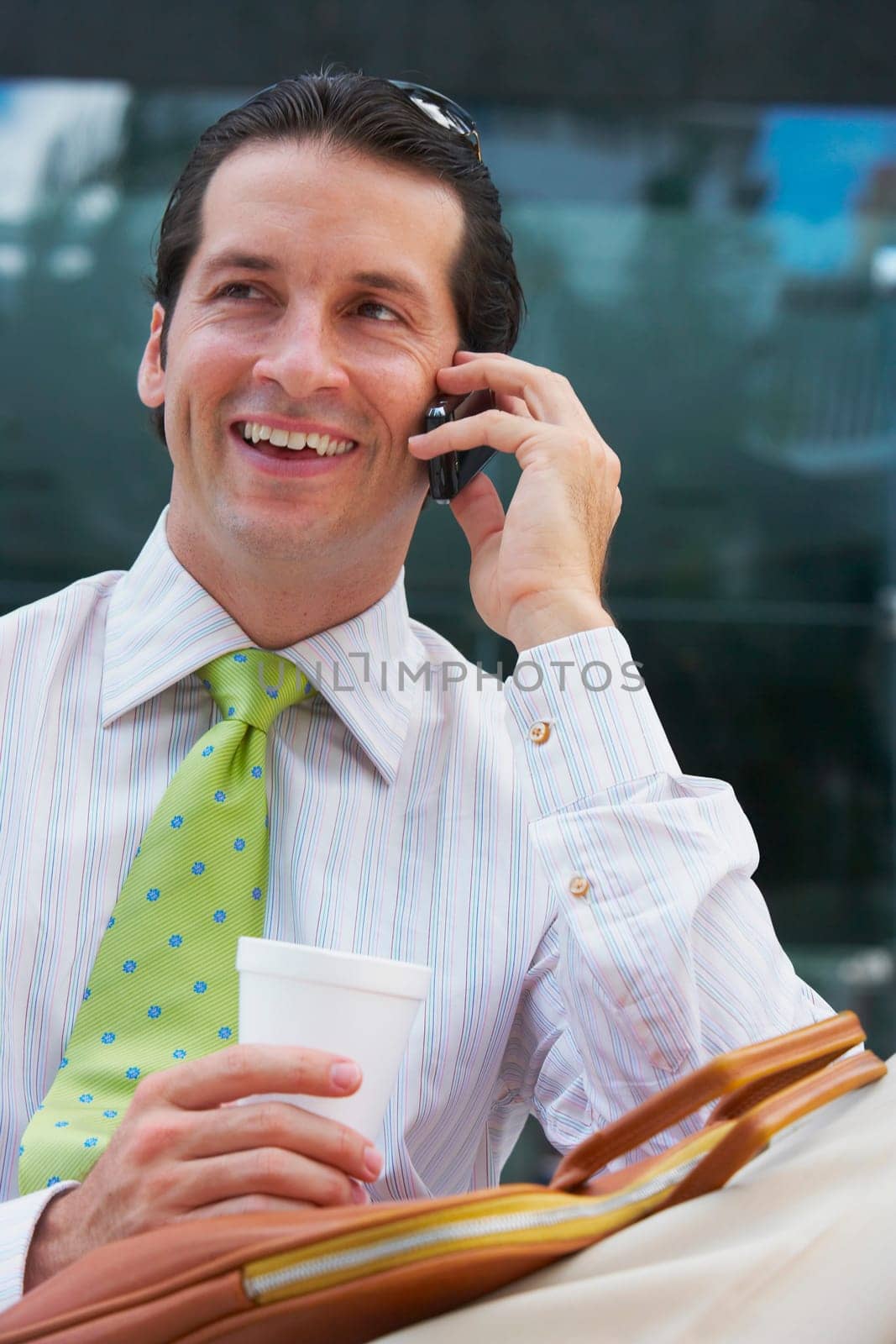 Close-up of a businessman talking on a mobile phone and smiling