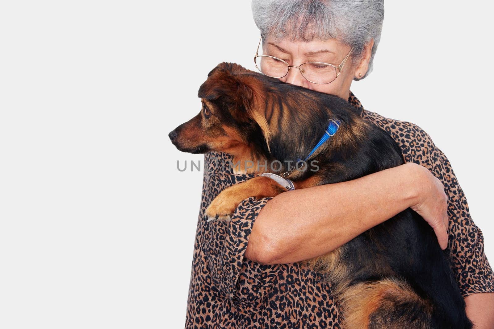 Senior woman kissing her pets