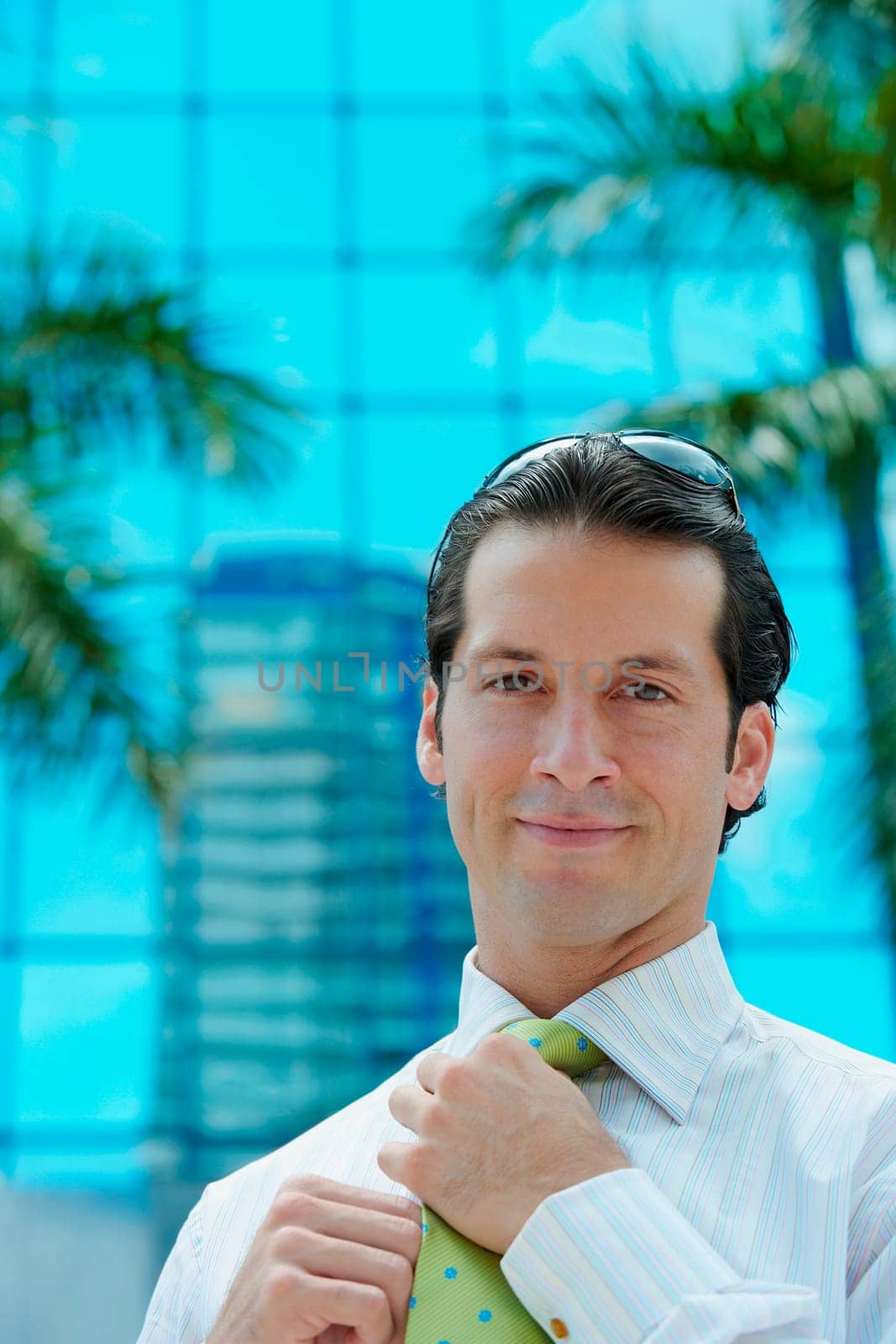 Portrait of a businessman adjusting his tie