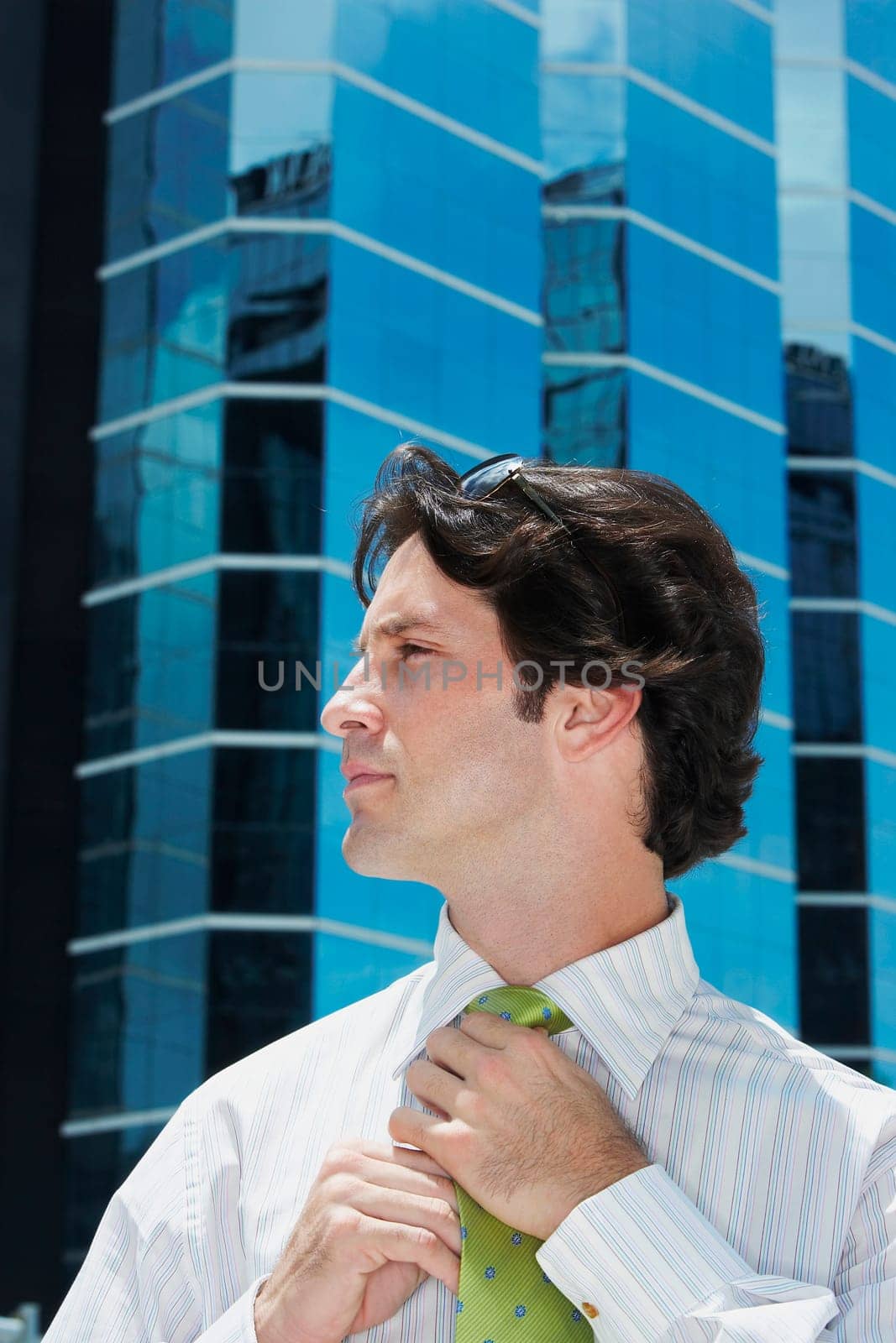 Close-up of a businessman adjusting his tie