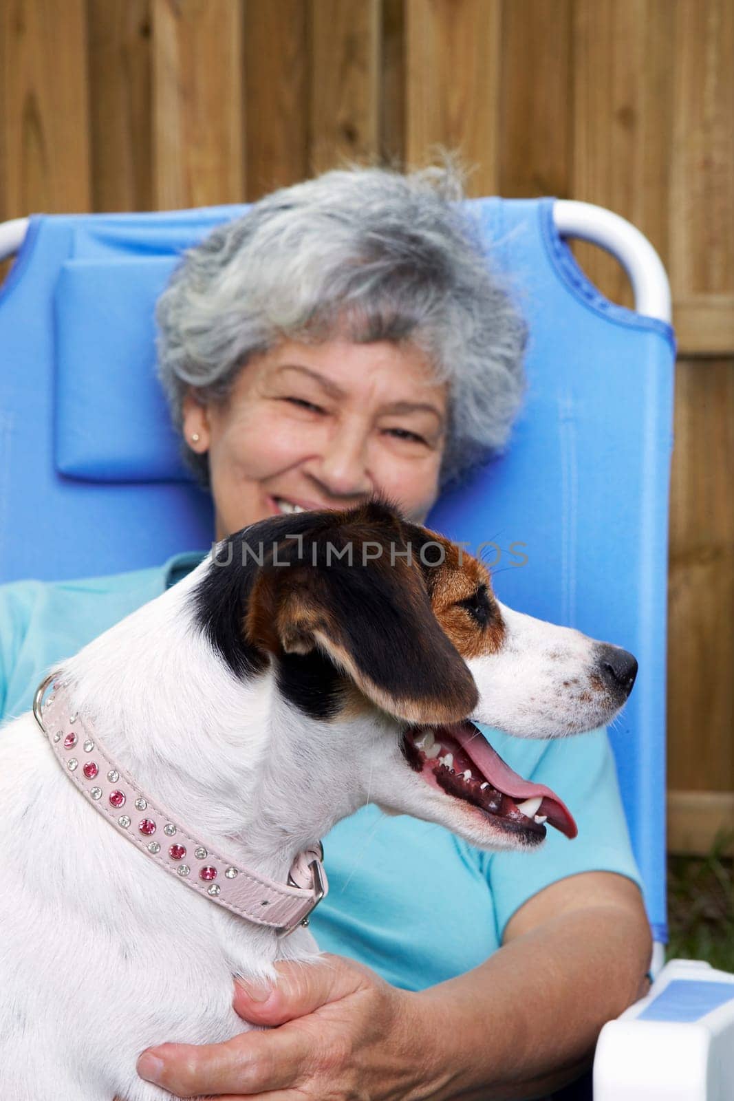 Senior woman with a dog and smiling