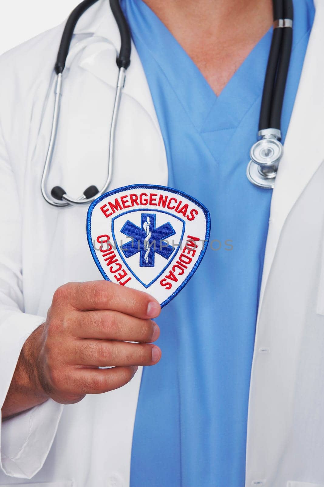 Mid section view of a male doctor holding a badge