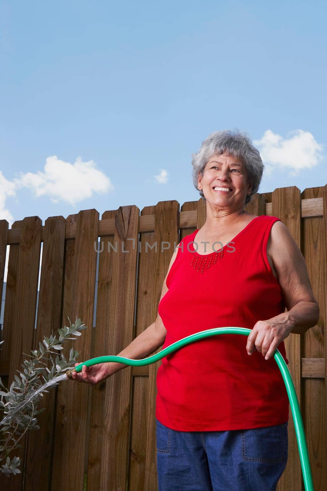 Senior woman watering a plant