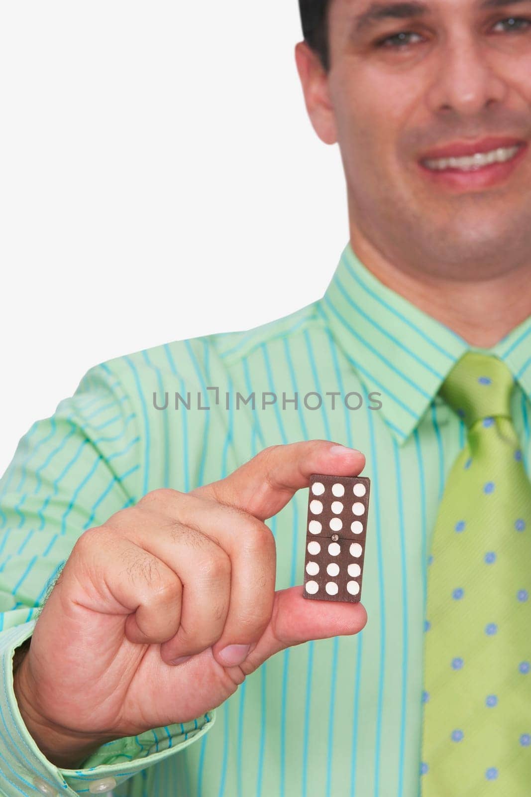 Front view of a businessman holding a domino and smiling