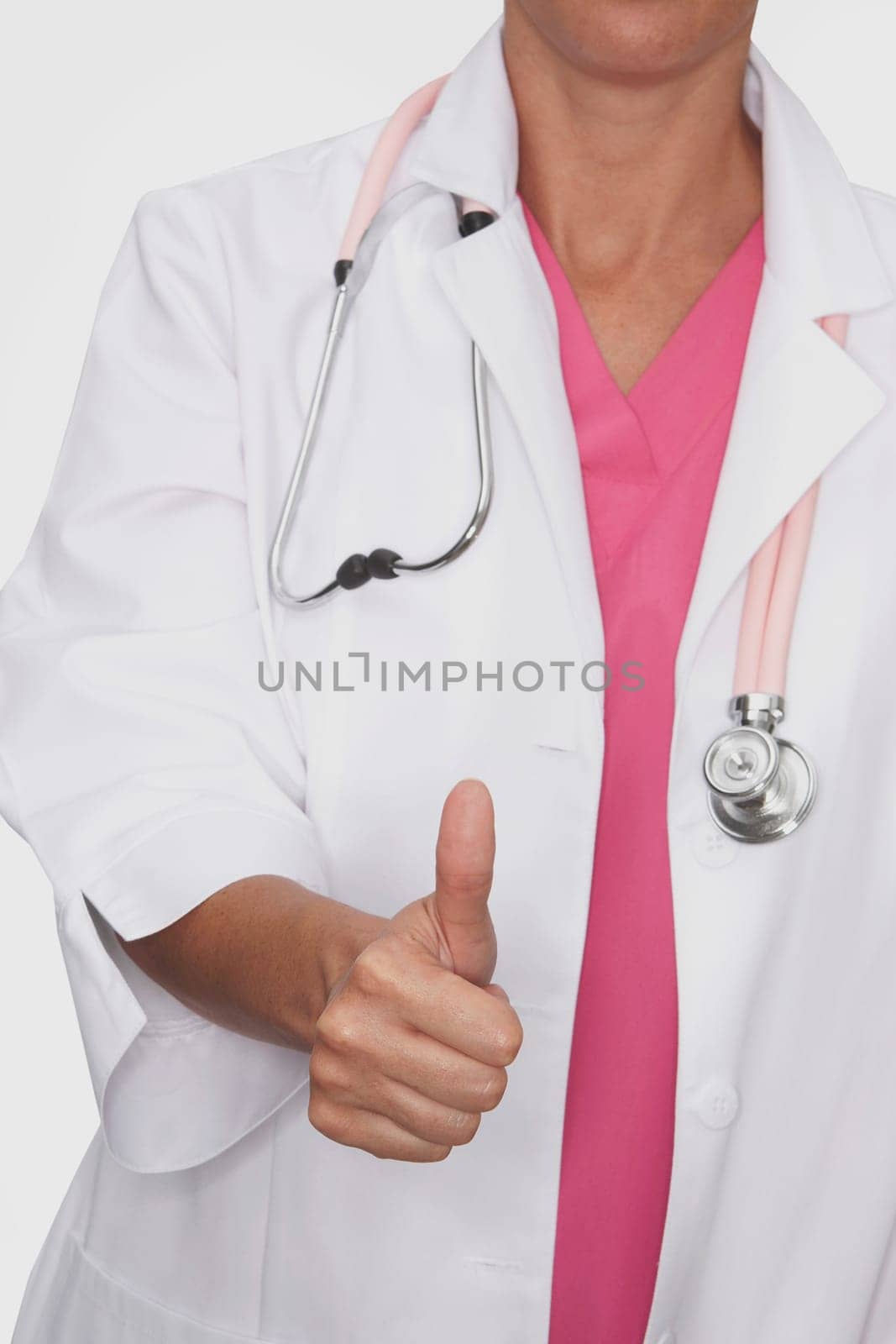 Close-up of a female doctor showing a thumbs up sign