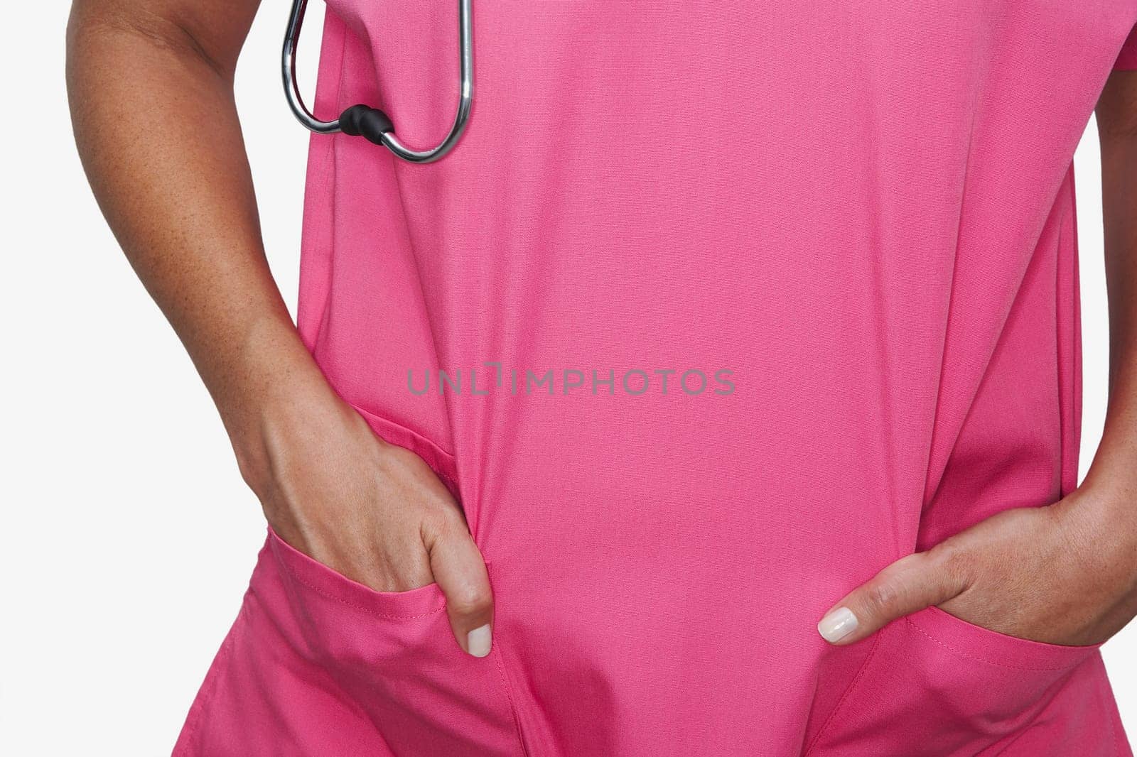 Mid section view of a female nurse standing with her hands in her pockets