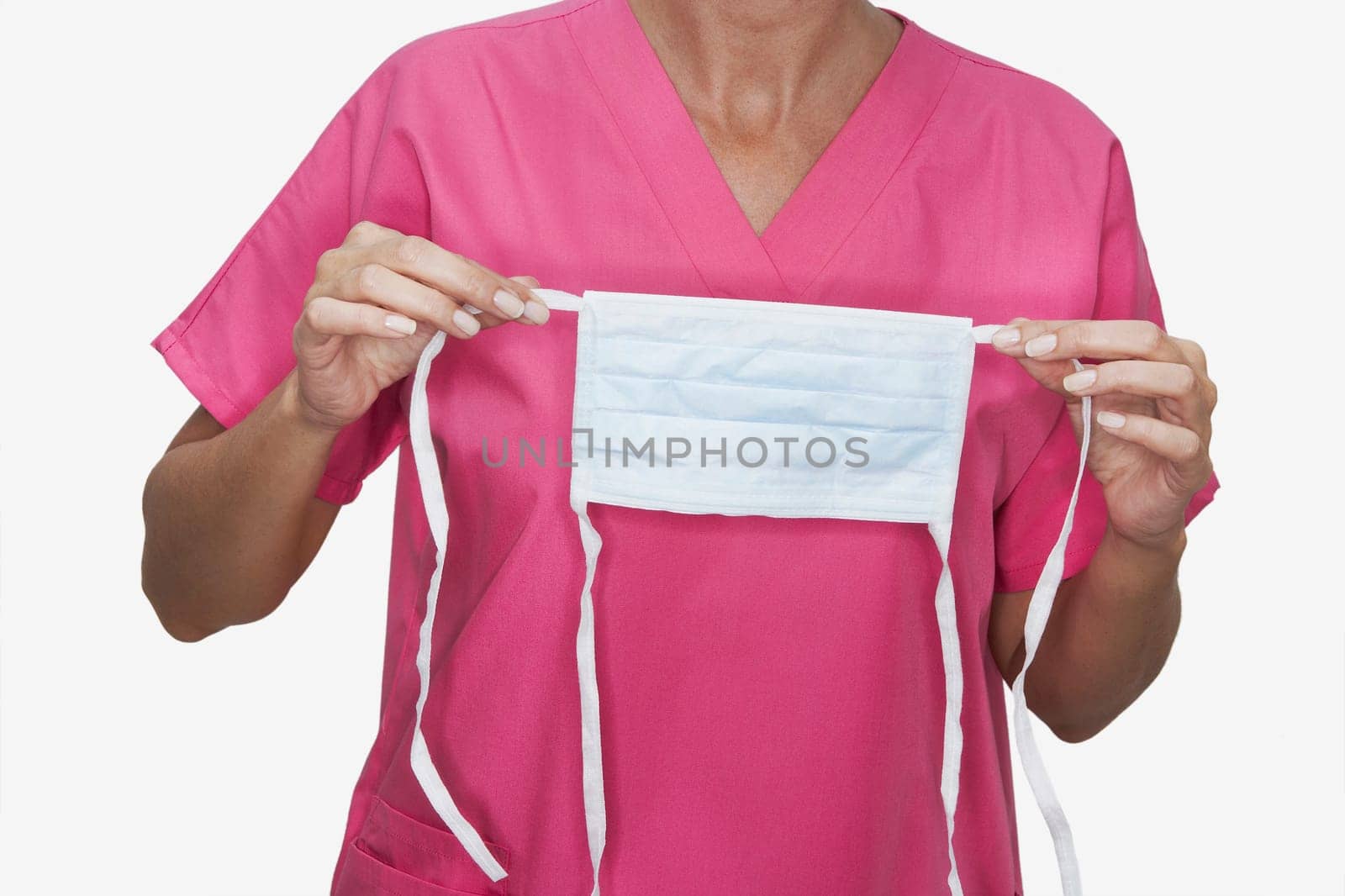 Mid section view of a female nurse holding a surgical mask