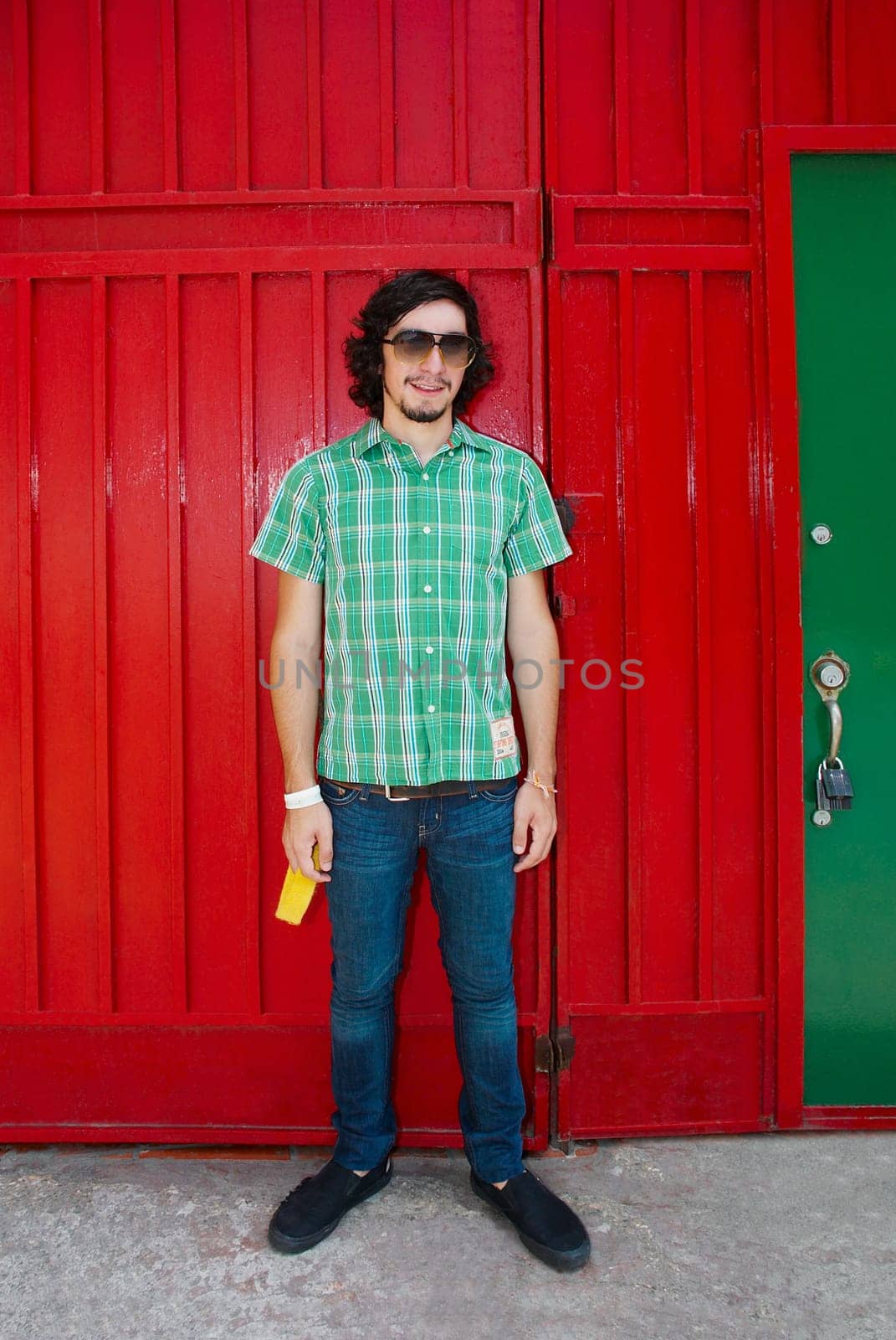Young man standing in front of a gate