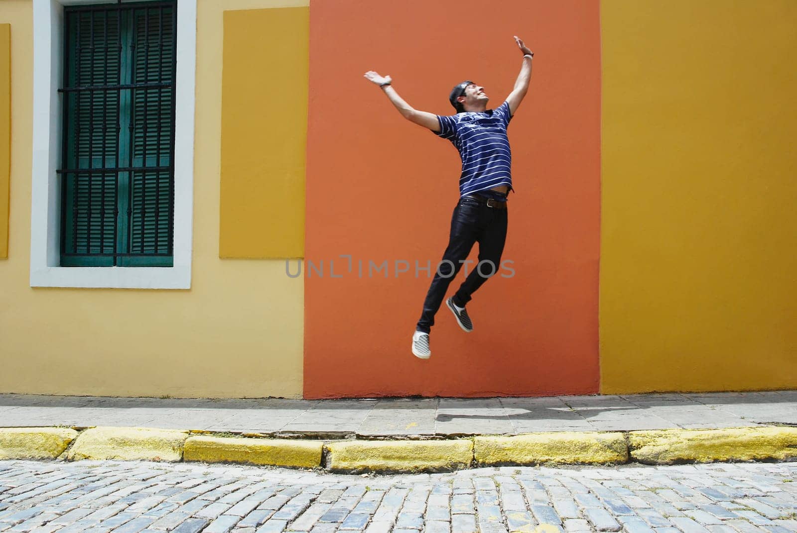 Young man jumping at the roadside