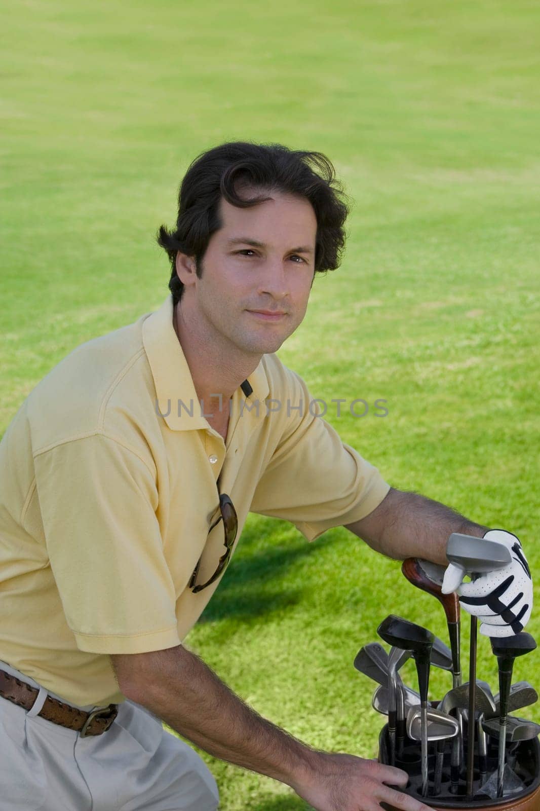 Portrait of a mid adult man standing with a golf bag