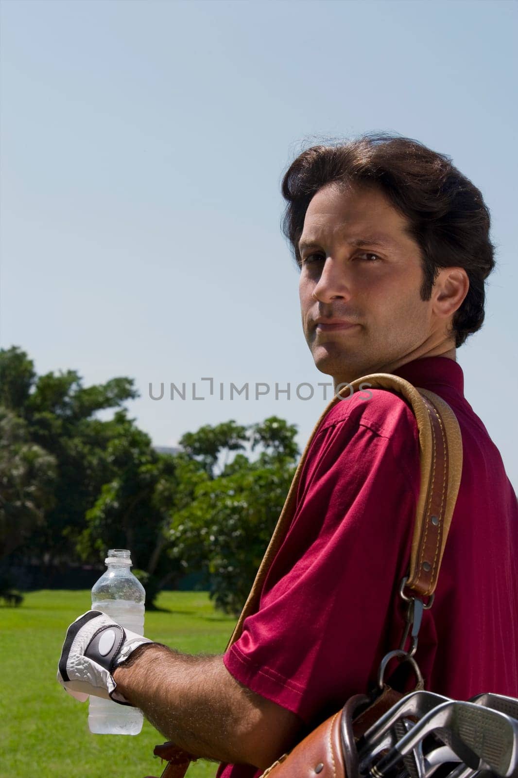 Portrait of a mid adult man holding a water bottle