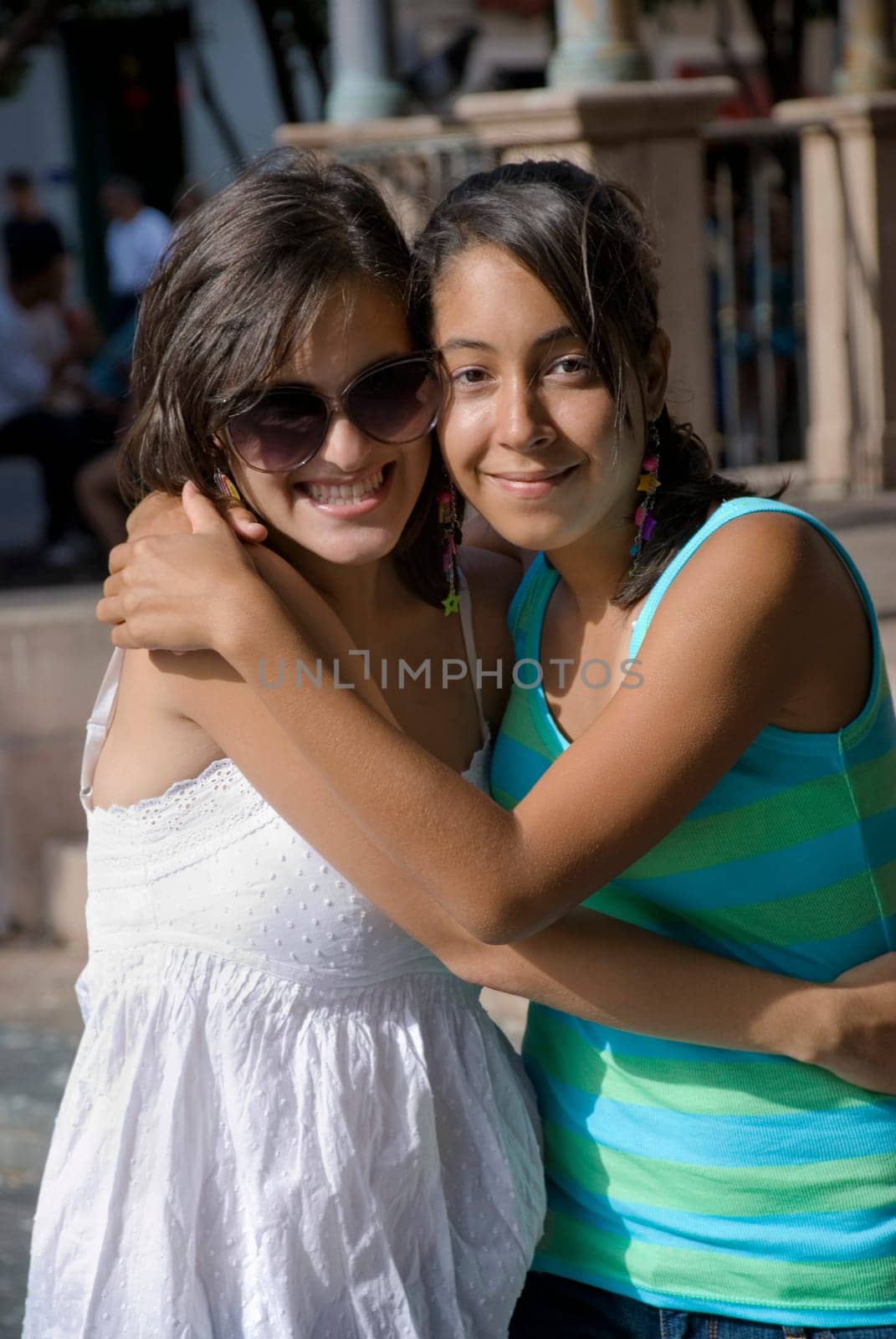 Portrait of two young women smiling and embracing each other