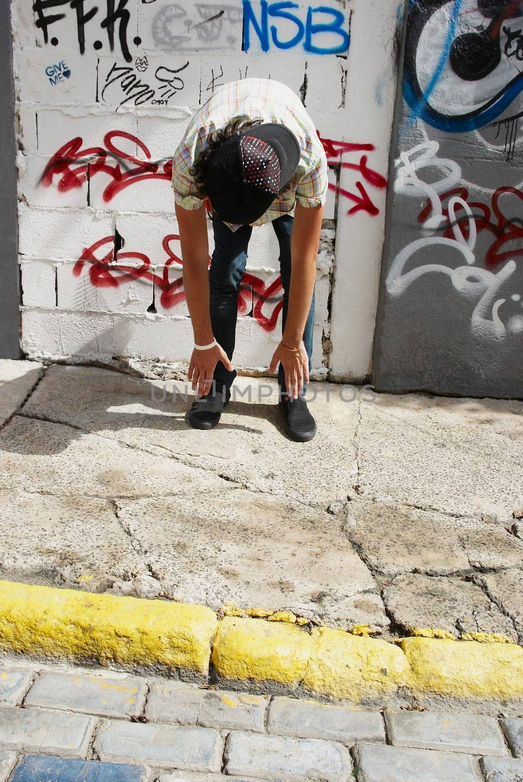Man exercising in front of a wall