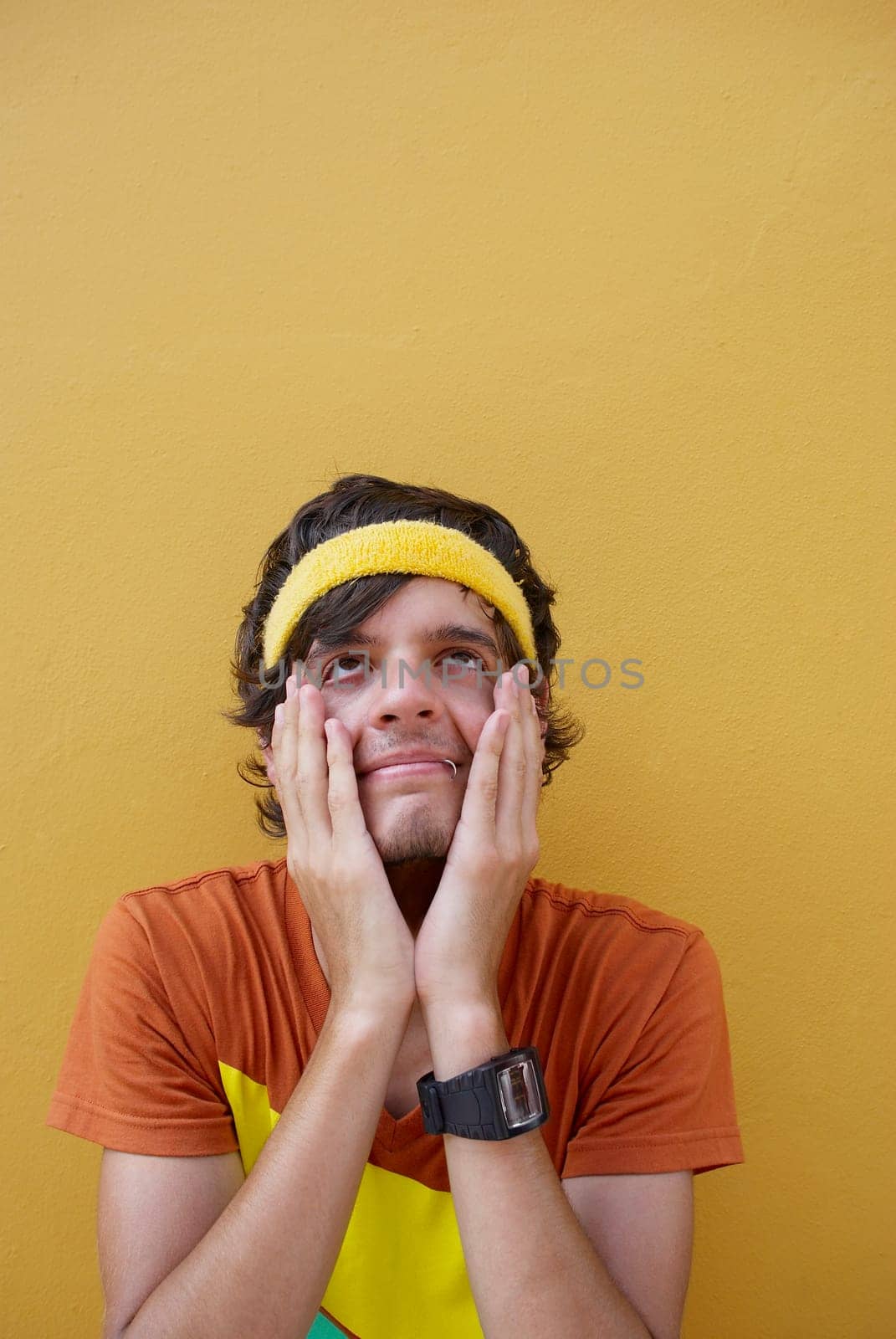 Close-up of a young man with his hands on his face