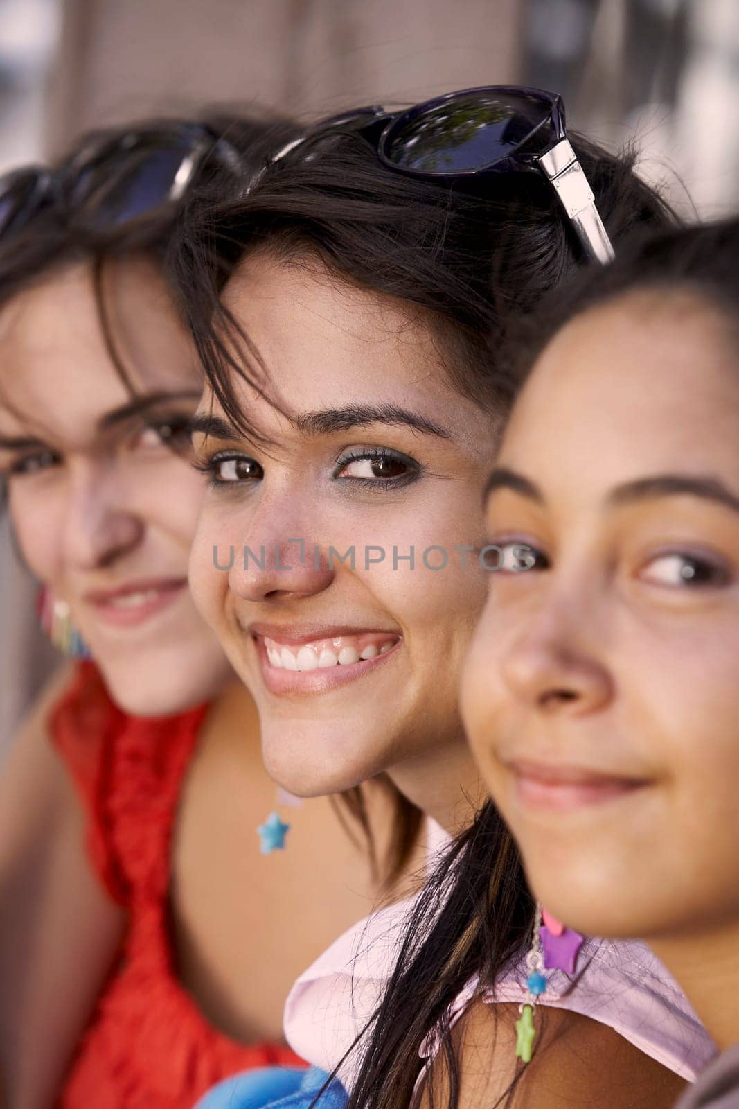 Portrait of three young women smiling