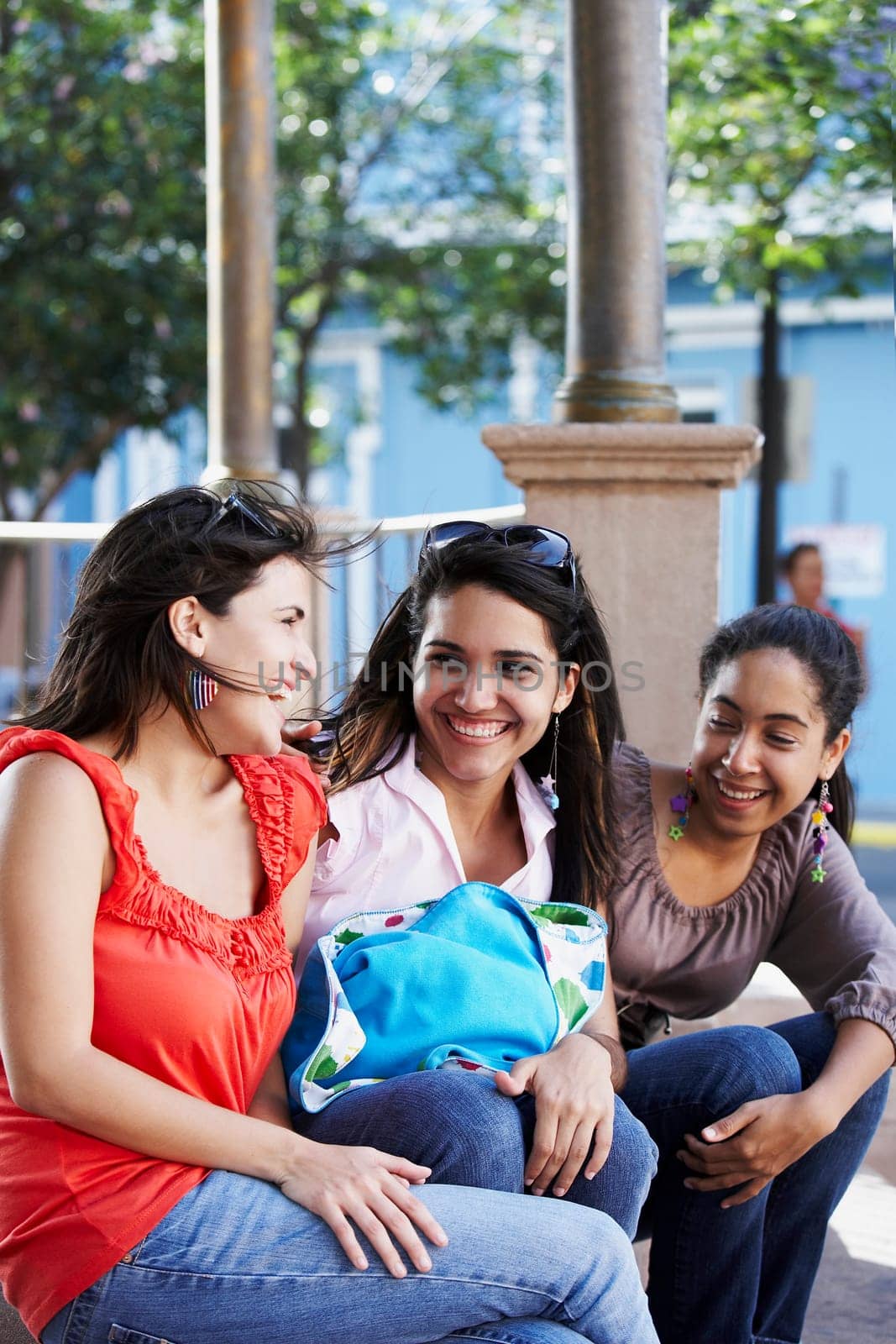 Three young women sitting together and smiling, Old San Juan, San Juan, Puerto Rico