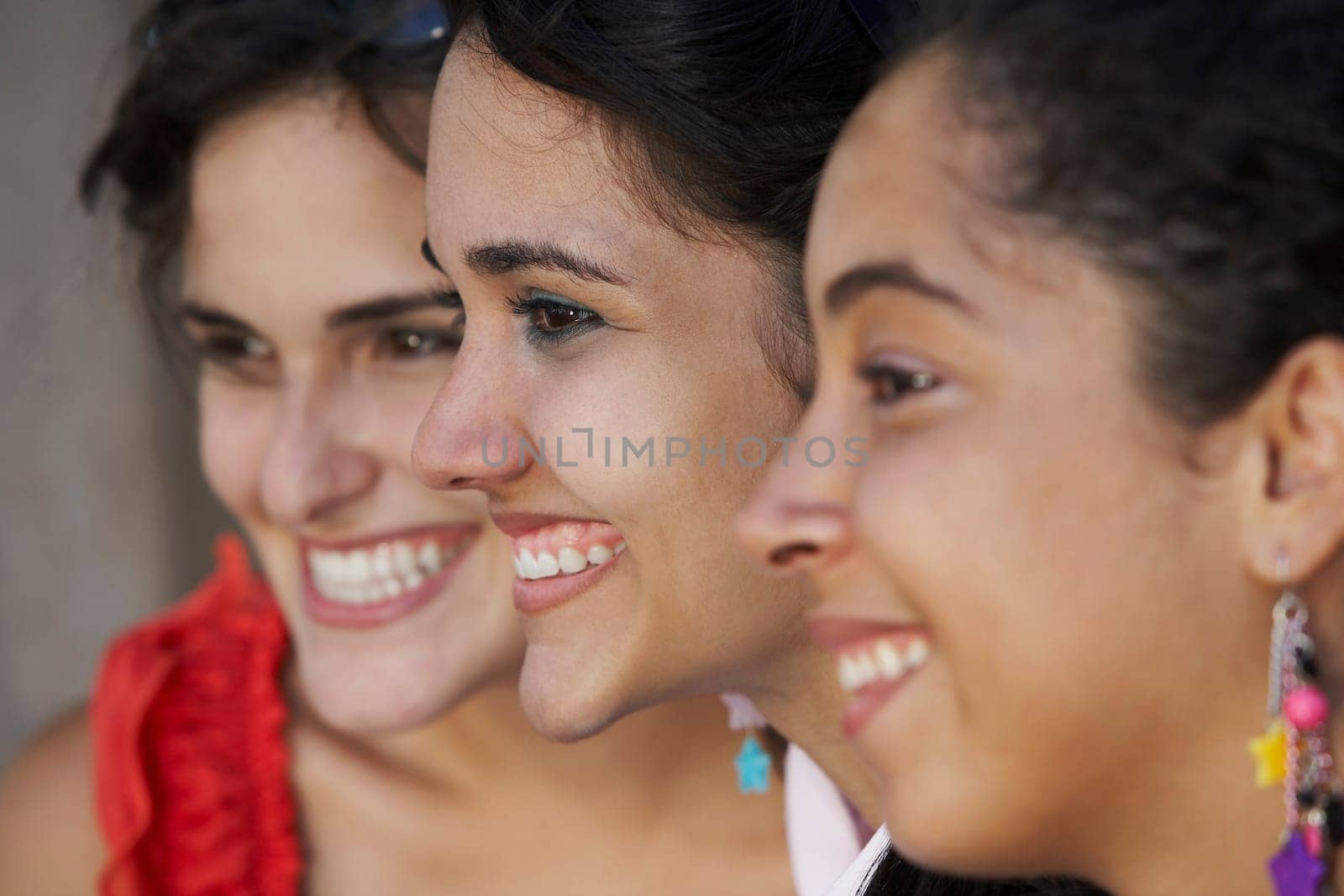 Close-up of three young women smiling