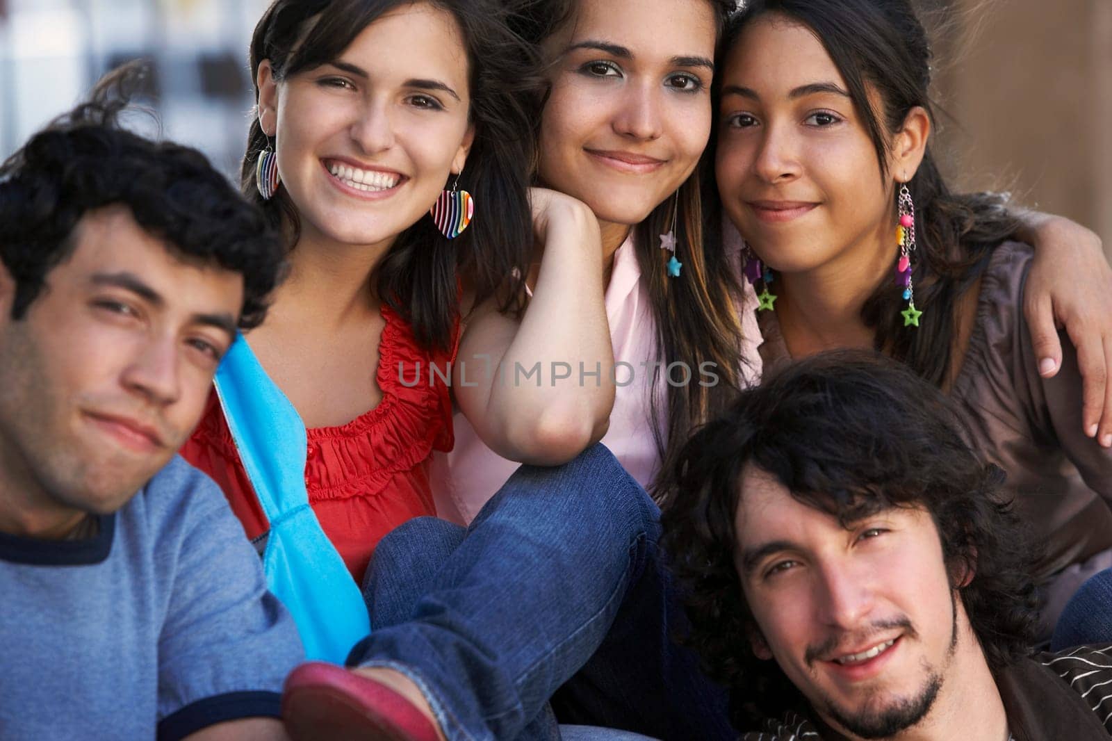 Portrait of three young women and two young men sitting together