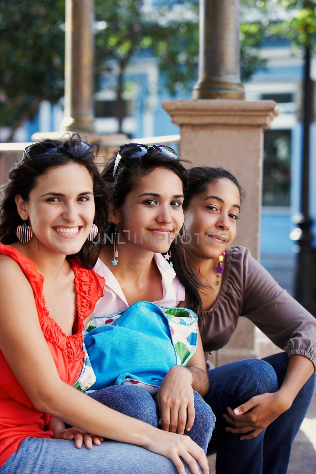 Portrait of three young women sitting and smiling, Old San Juan, San Juan, Puerto Rico