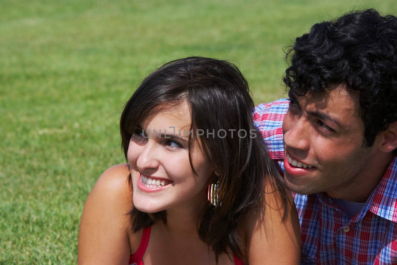 Close-up of a young couple smiling and looking away