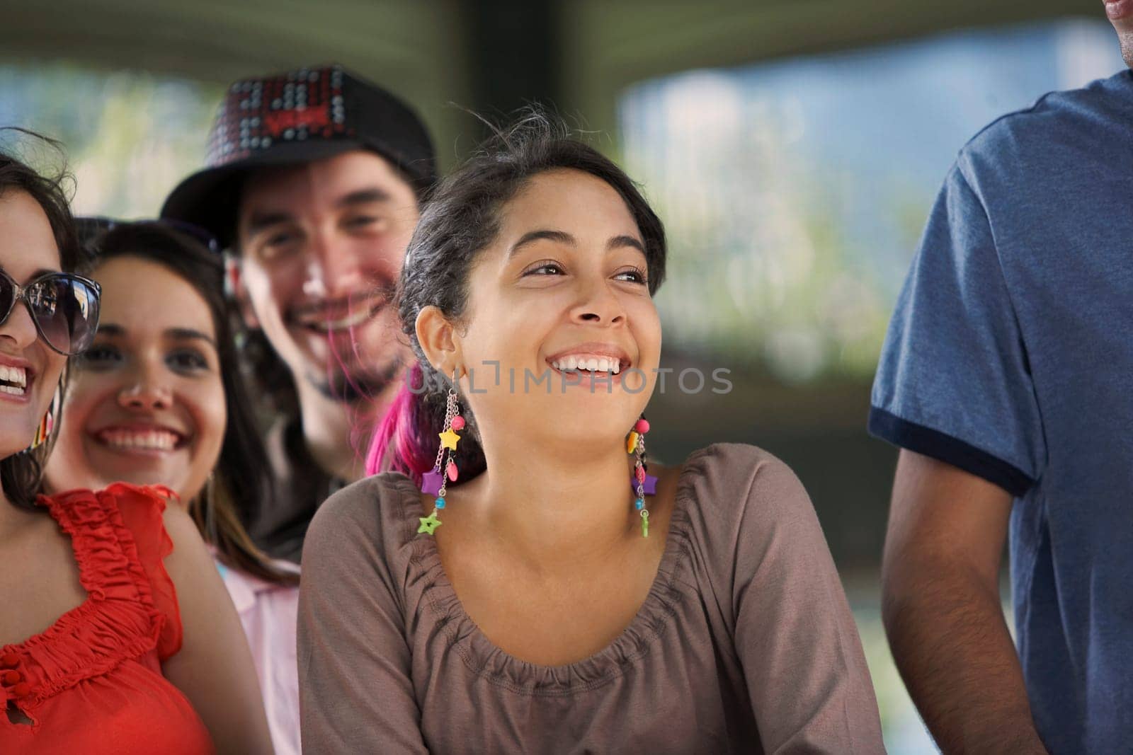 Close-up of three young women and a young man smiling