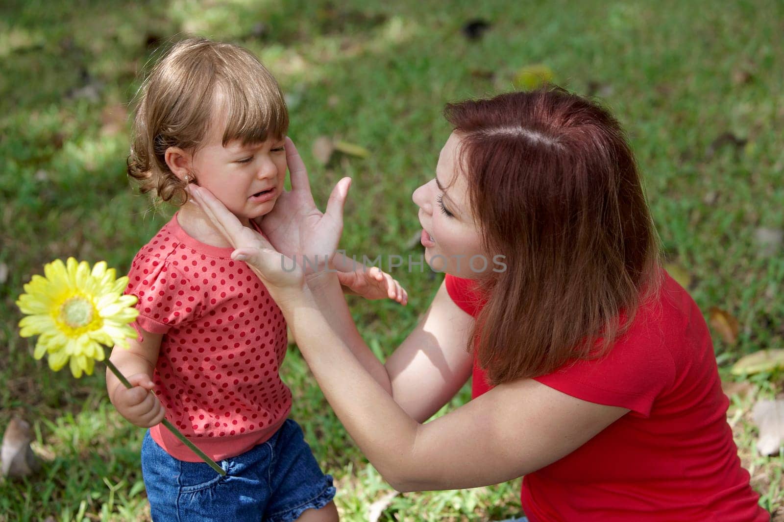 Close-up of a young woman consoling her daughter