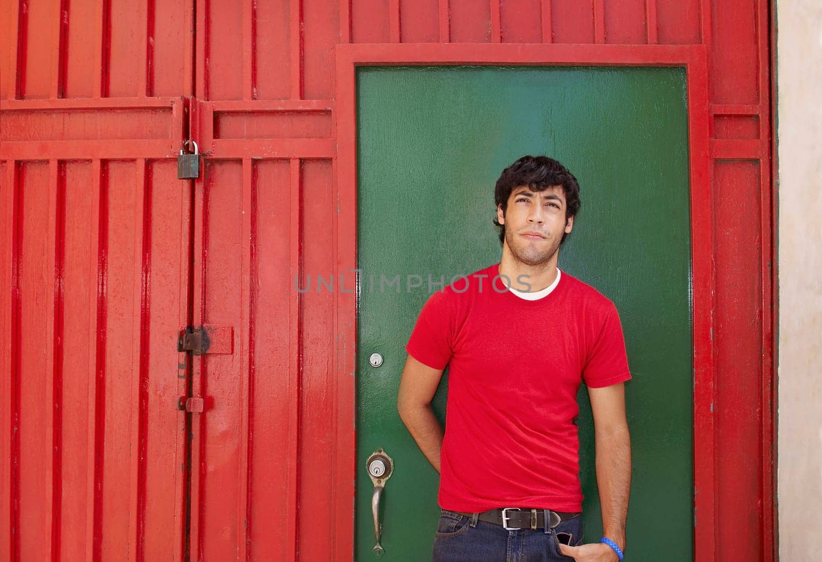 Young man standing in front of a closed door