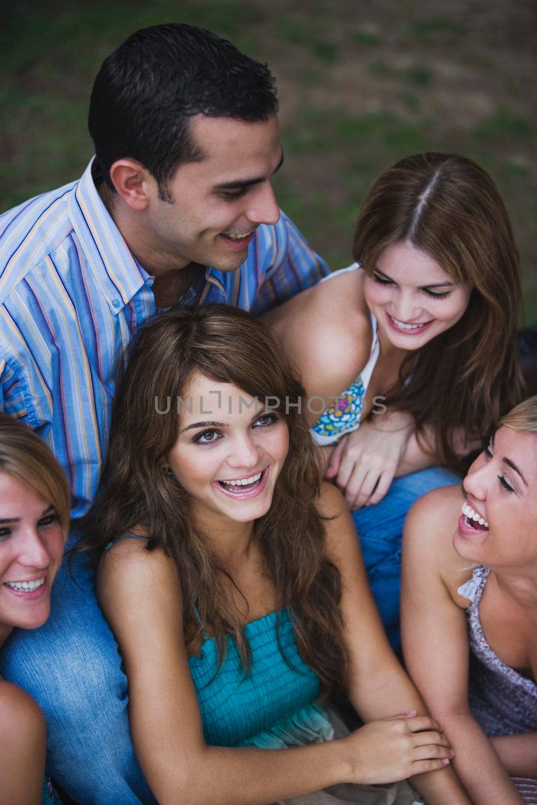 Close-up of four young women smiling with a young man