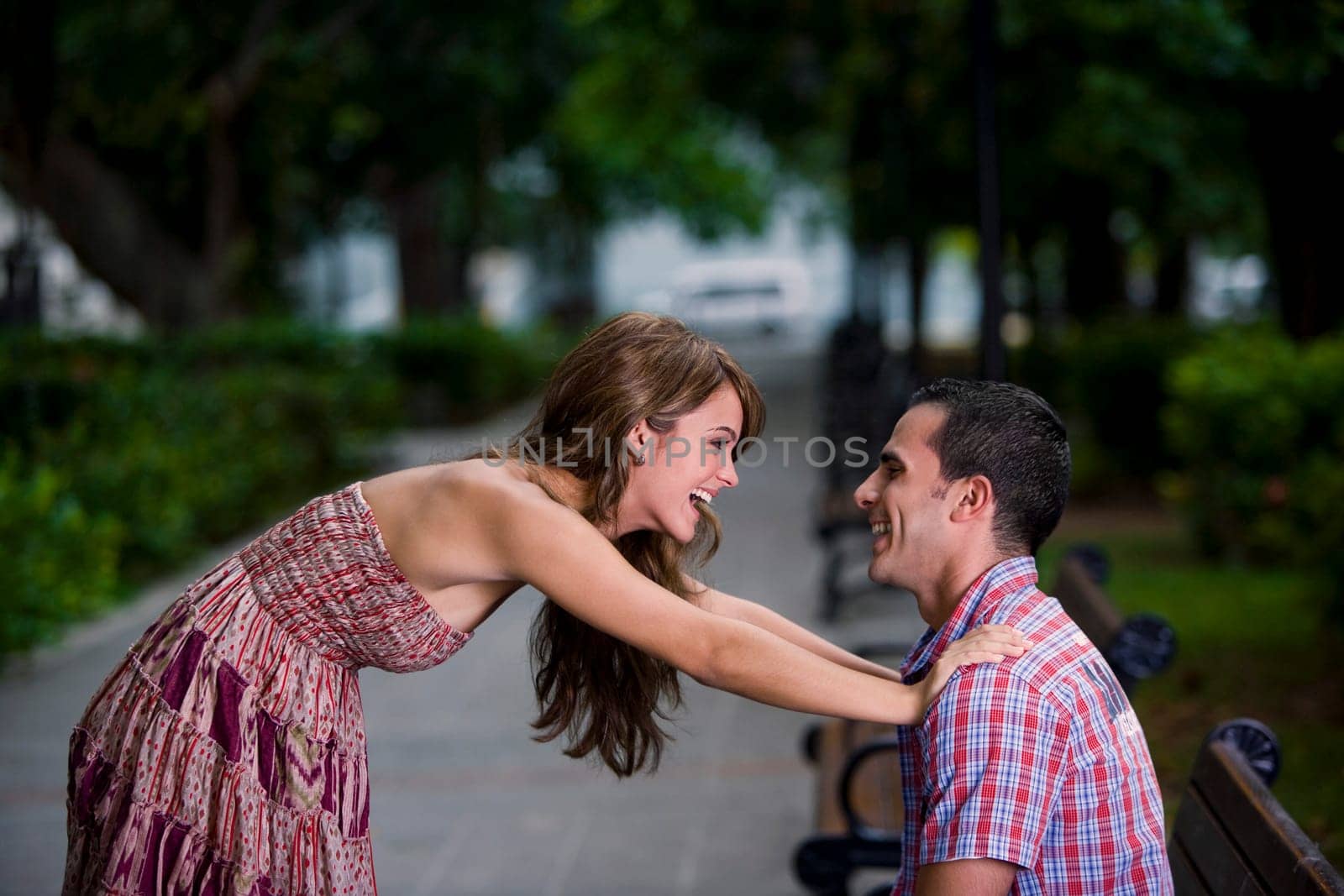 Side profile of a young couple looking at each other and smiling