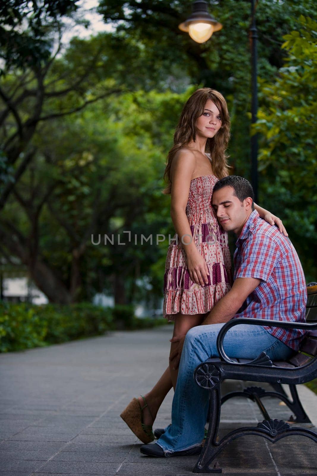 Side profile of a young couple romancing in a park